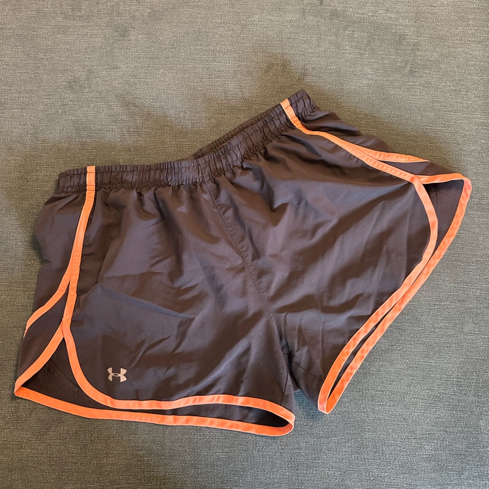 Under armor running shorts, orange trim. Lined and drawstring